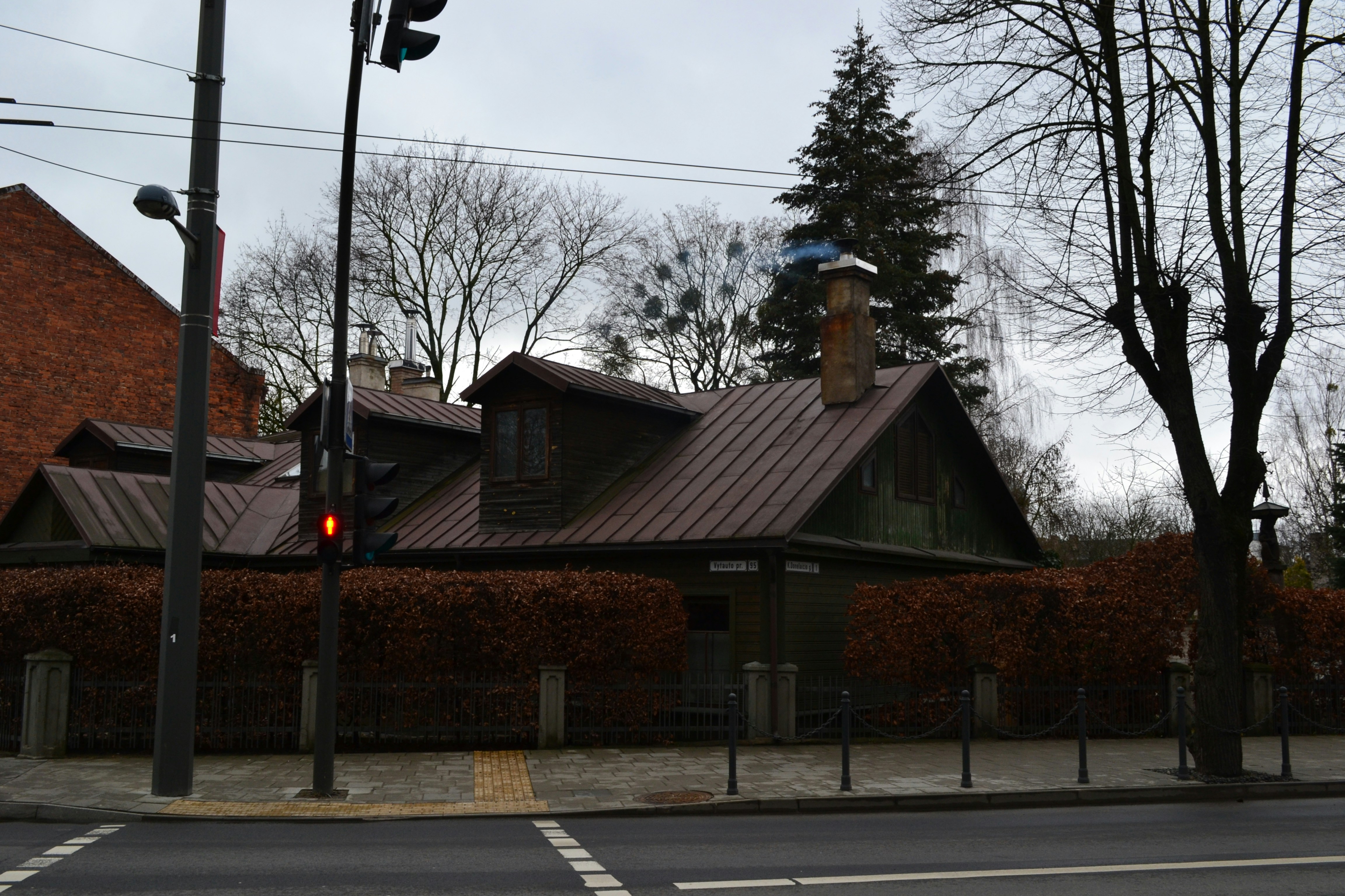 a building with a metal roof next to a street