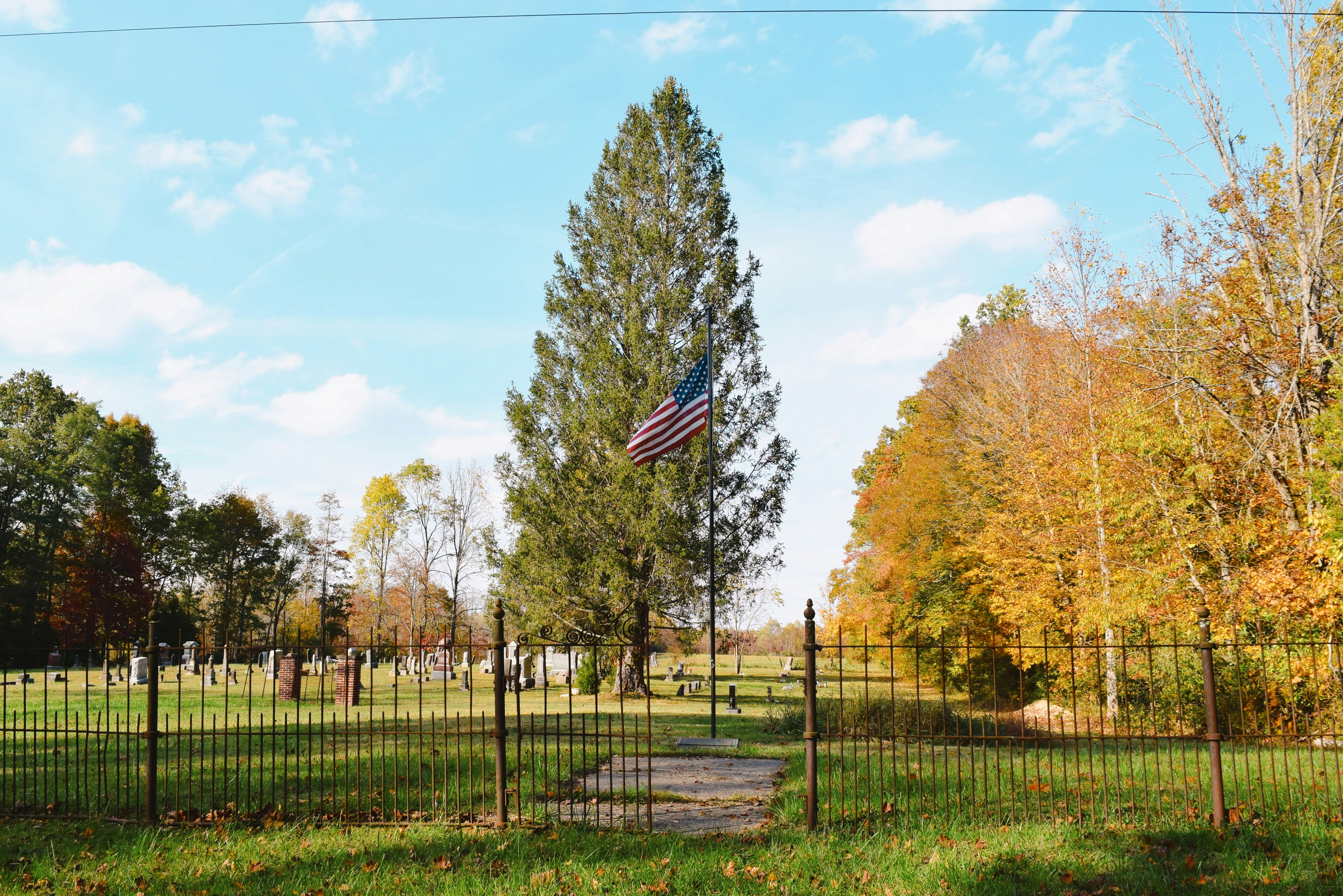 a fenced in area with a flag on top of it, 