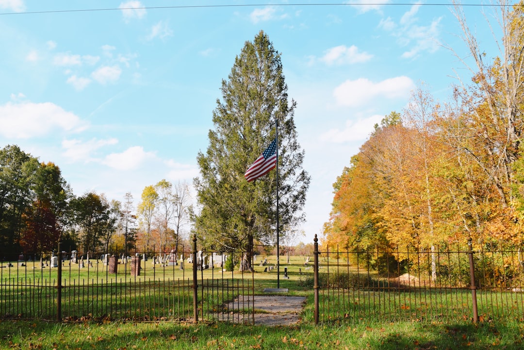 a fenced in area with a flag on top of it,