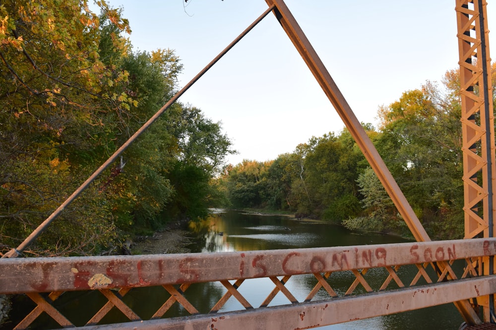 a bridge over a river with trees in the background