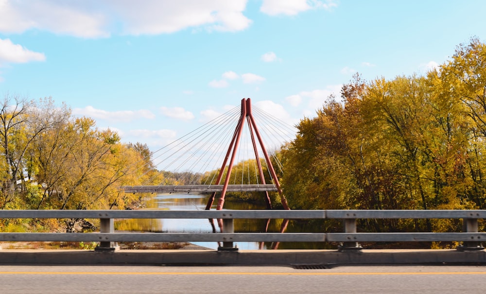 a bridge over a body of water surrounded by trees