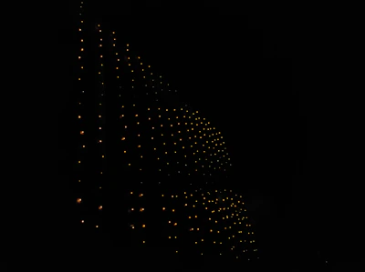 A pixel grid heatmap glowing softly in phosphor cyan on a charcoal background.