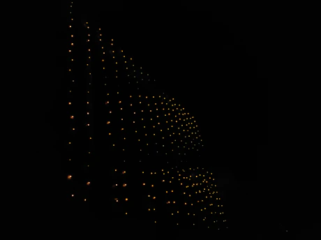 A sleek black and gold circuit board pattern glowing softly under warm light.