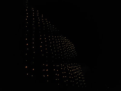 A deep science aesthetic showing layered grids with glowing points fading into a dark background