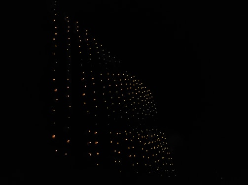 A glowing 8k portrait grid with vibrant neon highlights on a dark textured background.