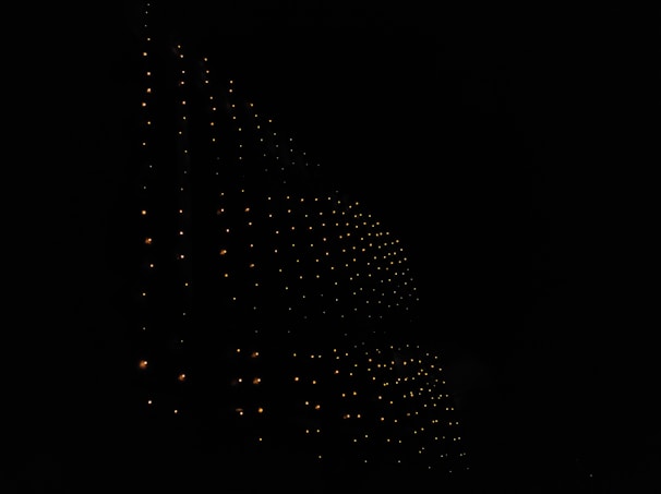 Dark background featuring a glowing grid pattern representing complex computing layers.