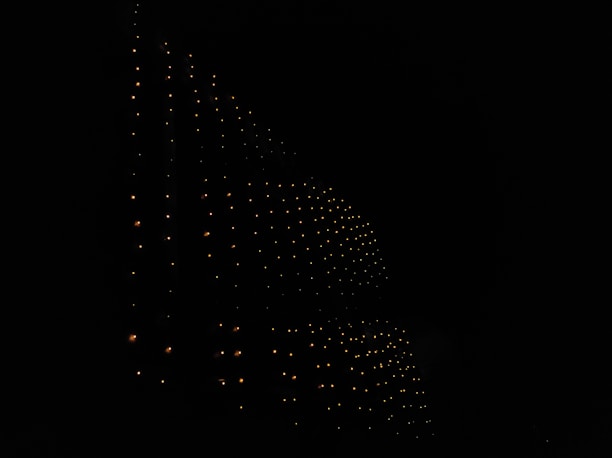 Dark-themed abstract tech background with subtle glowing lines forming a network pattern.