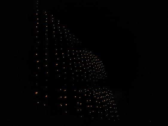 A high-resolution dark background with subtle geometric patterns and faint blockchain lines glowing softly at the center.