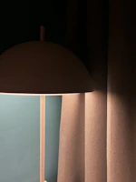 A minimalist setting featuring a Magma lamp illuminating a cozy corner with fiery tones.