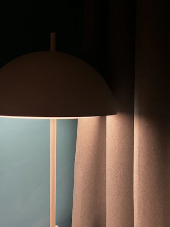 A smart LED lamp casting colorful light in a stylish, minimalistic room.