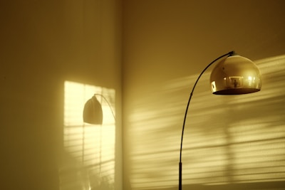 Sophisticated matte gold 3D printed lamp casting soft shadows in a cozy room.