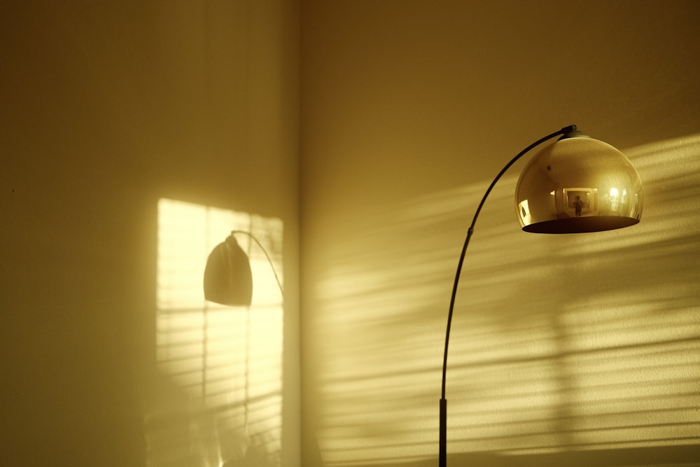 a floor lamp casts a shadow on a wall