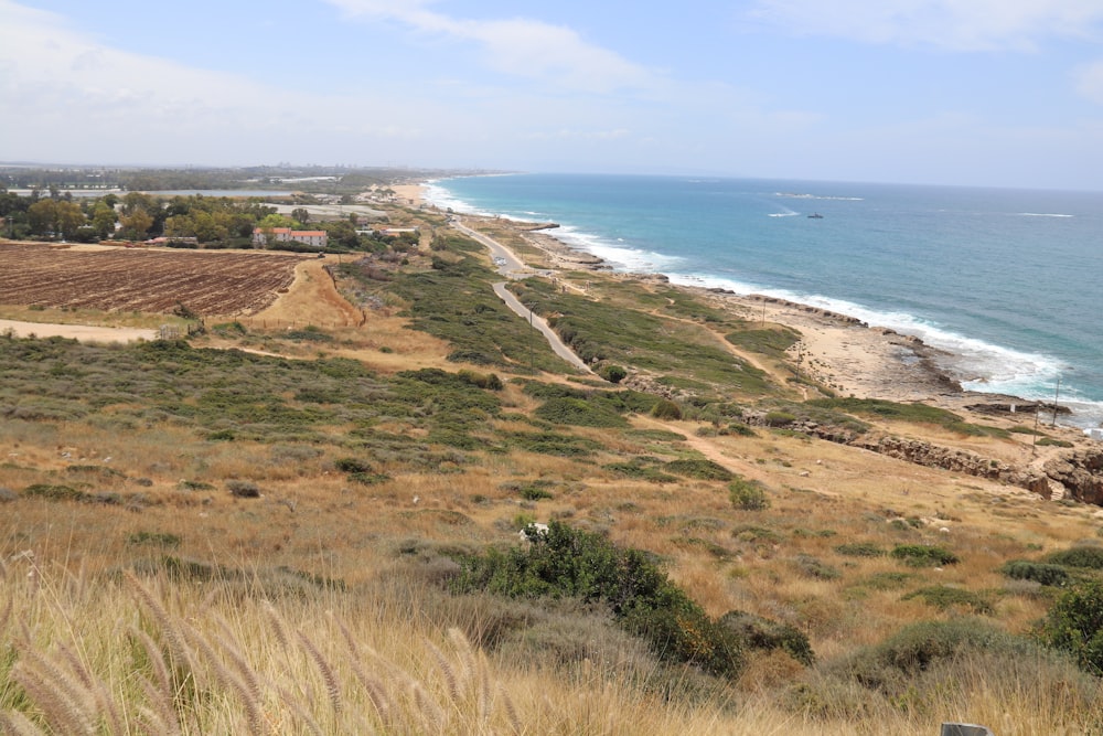 a view of a beach from a hill overlooking the ocean