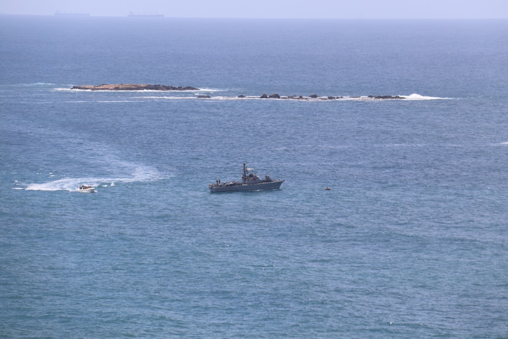 a small boat in the middle of a large body of water