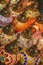 Artist carefully crafting a unique lamp inspired by world religions.