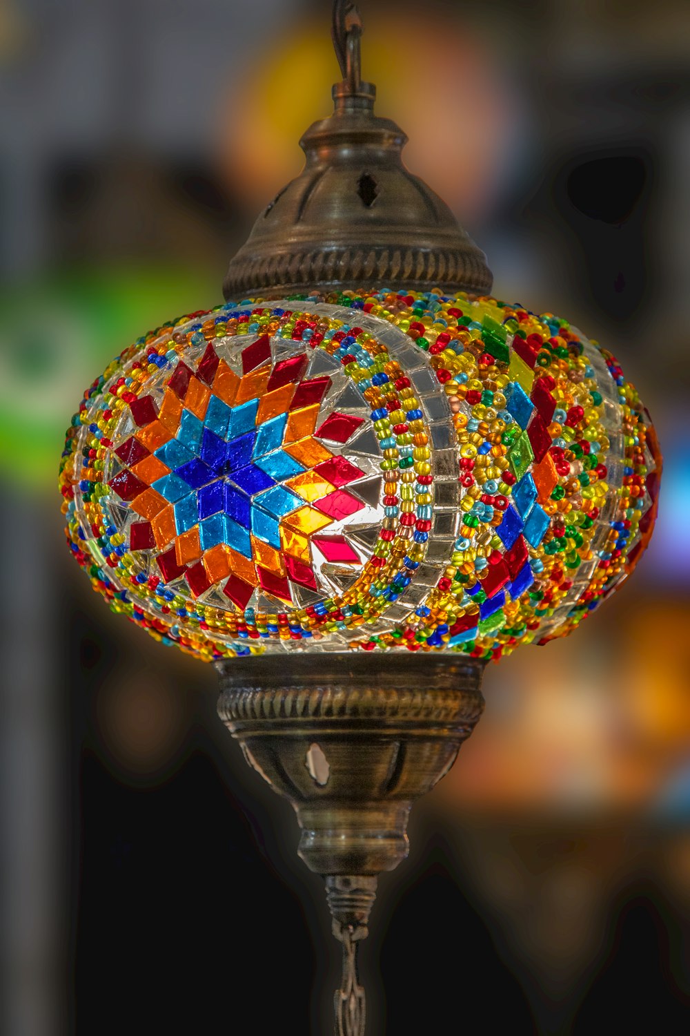 a multicolored lamp hanging from a metal pole