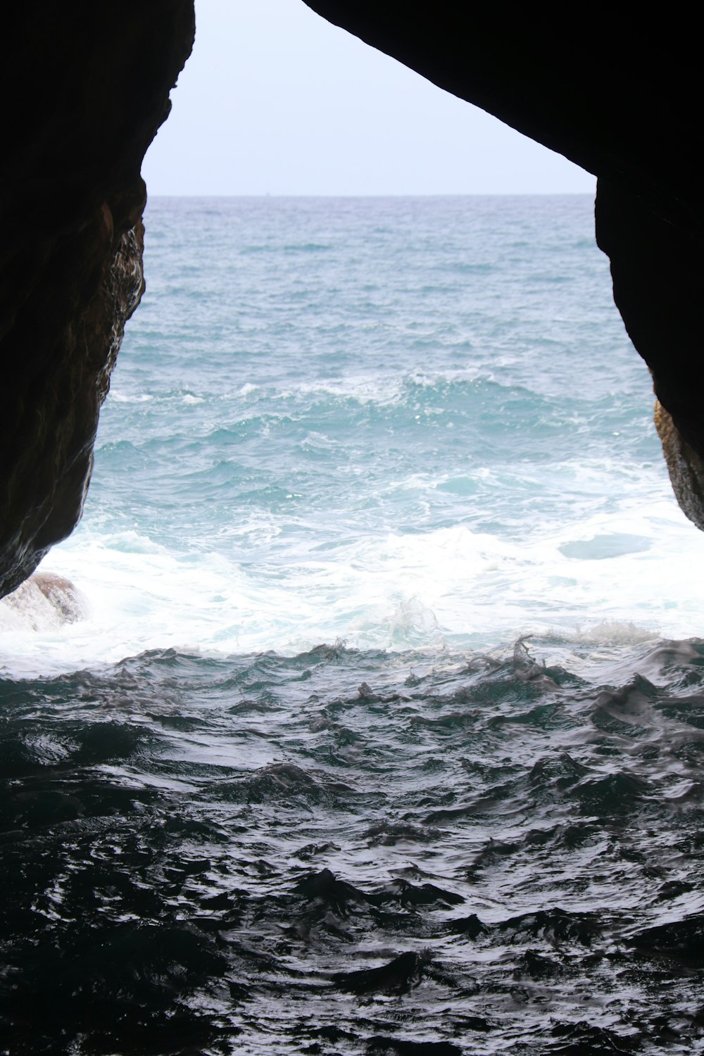 a view of the ocean from inside a cave