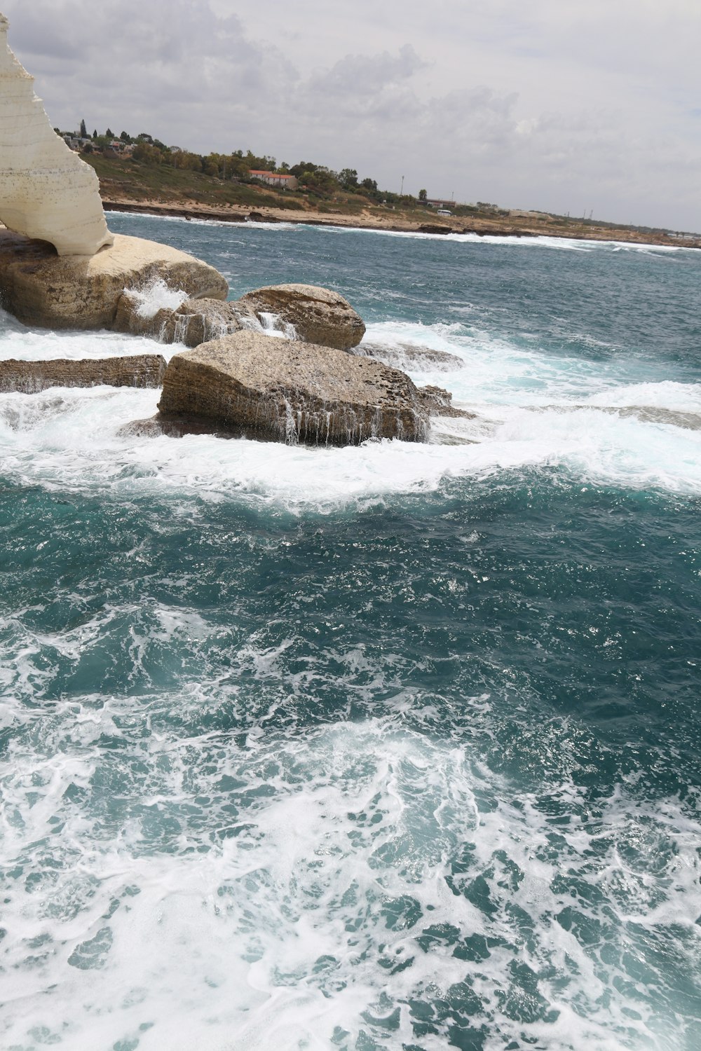 a large body of water next to a rocky cliff