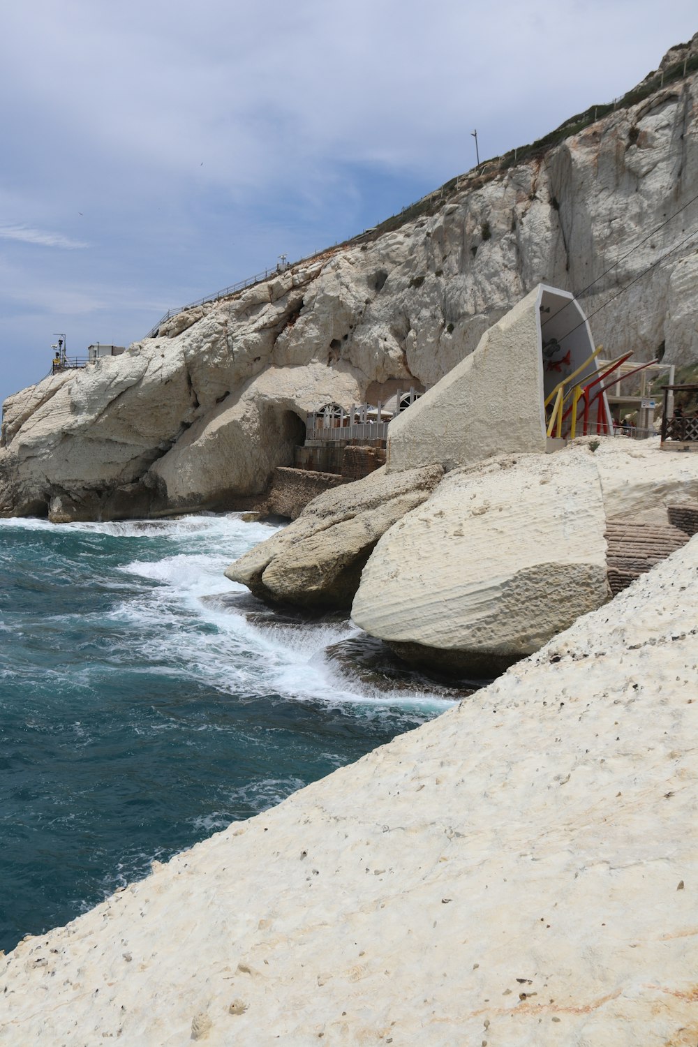 a large body of water next to a rocky cliff