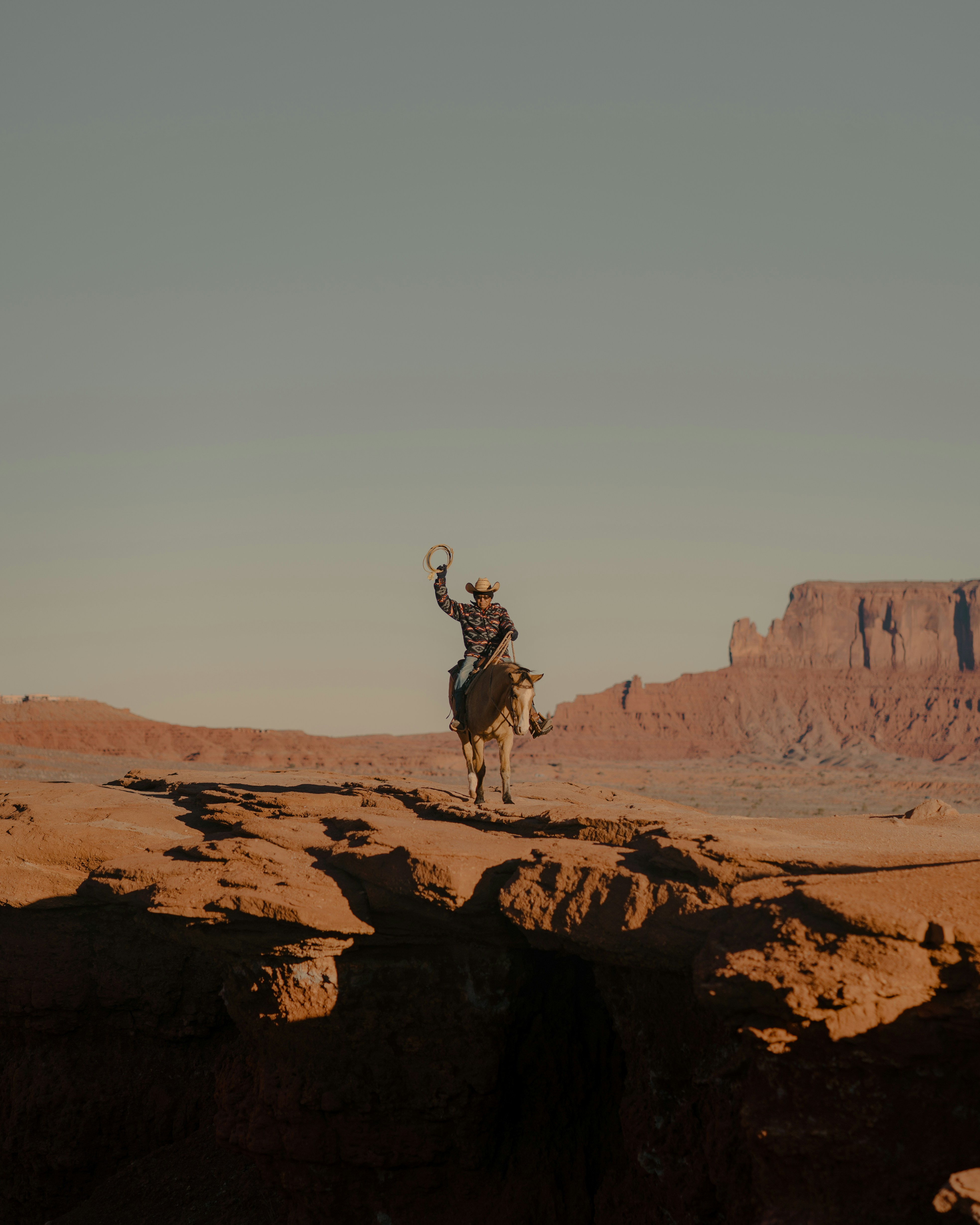a man riding a horse in the desert