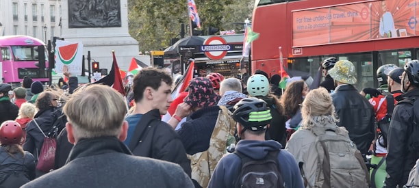 A close-up of a Londoner holding a sign that reads 'Make London Great Again'.