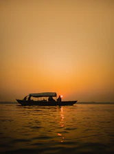 a boat with two people in it on a body of water