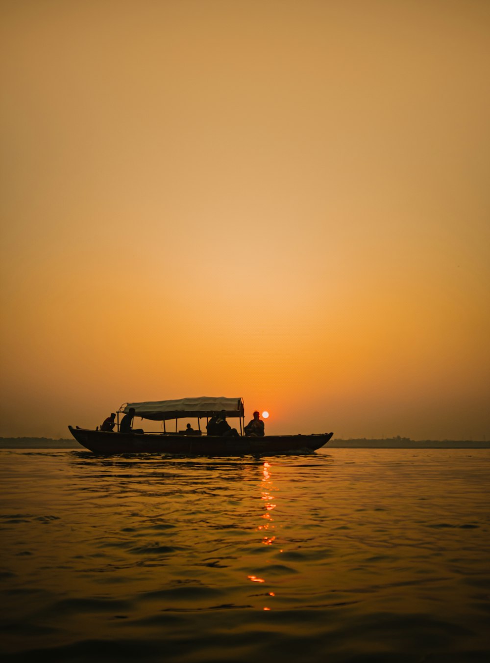 a boat with two people in it on a body of water