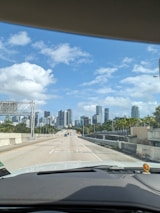 A scenic view of a city skyline from a car window.