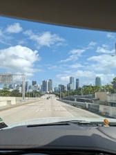 A cityscape viewed from inside a comfortable car during a smooth ride.