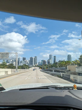 City skyline viewed from a car window during a smooth ride.