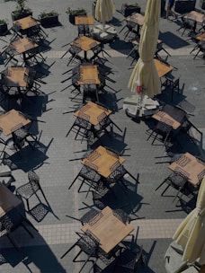 An inviting outdoor terrace of a local café with tables and umbrellas.