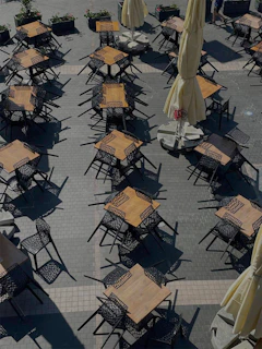 A panoramic view of a stylish café terrace with parchment-colored furnishings captured in high resolution.