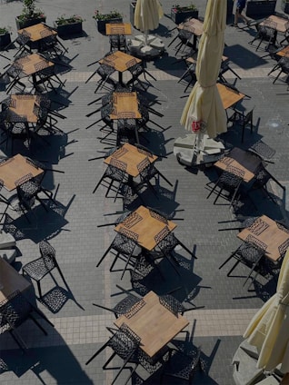 An inviting outdoor terrace of a local café with tables and umbrellas.