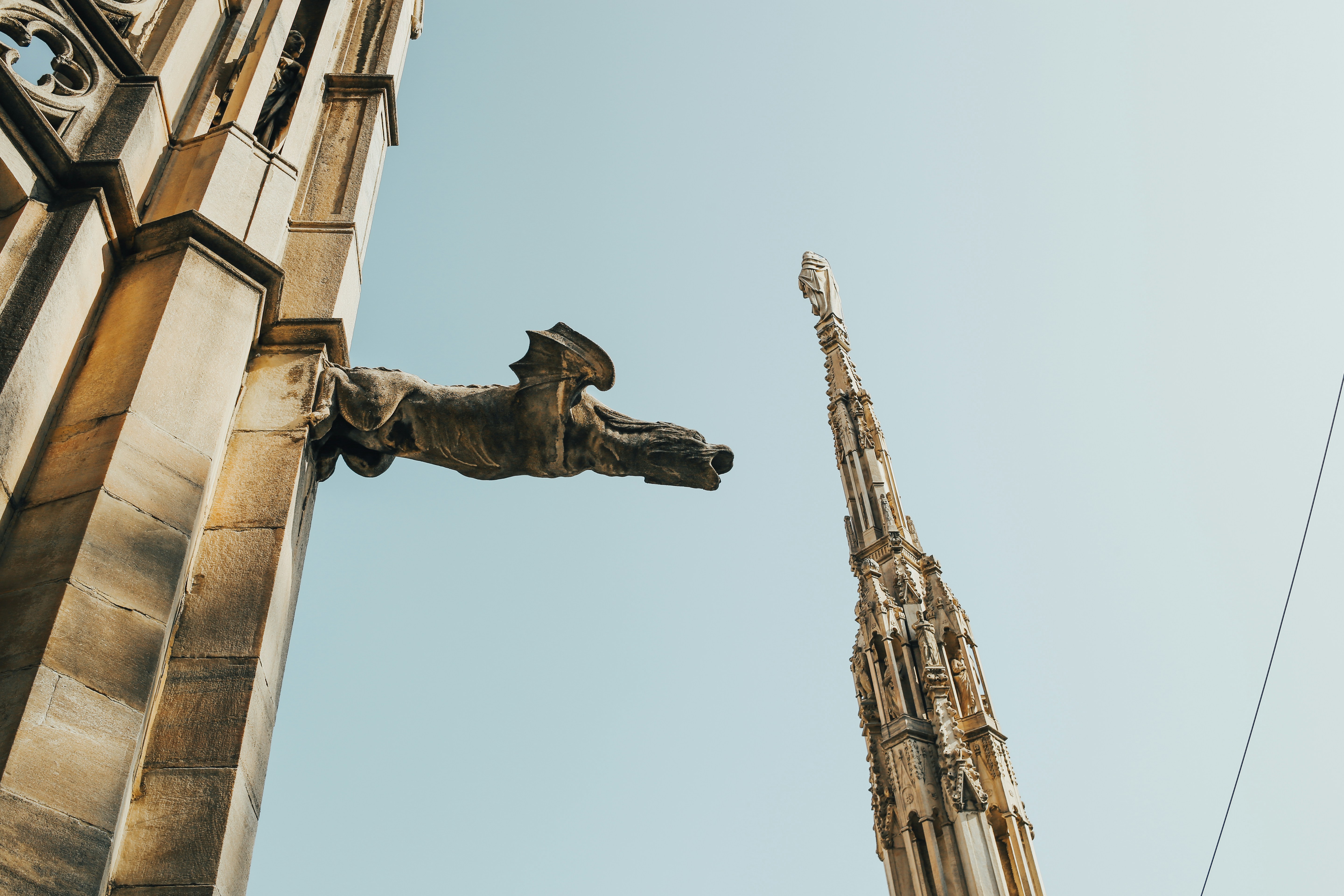 a tall building with a statue on the side of it, 