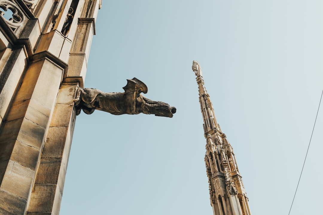 a tall building with a statue on the side of it,
