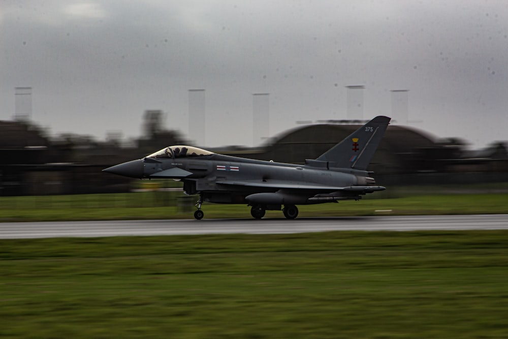 a fighter jet taking off from an airport runway