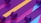 Multiple rolls of colorful plastic material are unrolled and laid out parallel to each other. The materials display a vibrant color scheme with prominent purple, yellow, and blue tones.