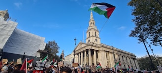 A group of community members and staff gathered at a newly completed housing project in East Jerusalem, smiling and celebrating.