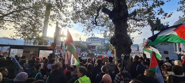 A diverse group of people planting trees together under a bright sky symbolizing hope and unity in the Arab region