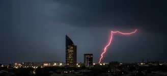 Icon showing a tall office building with a lightning bolt symbol.