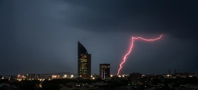 Icon showing a tall office building with a lightning bolt symbol.