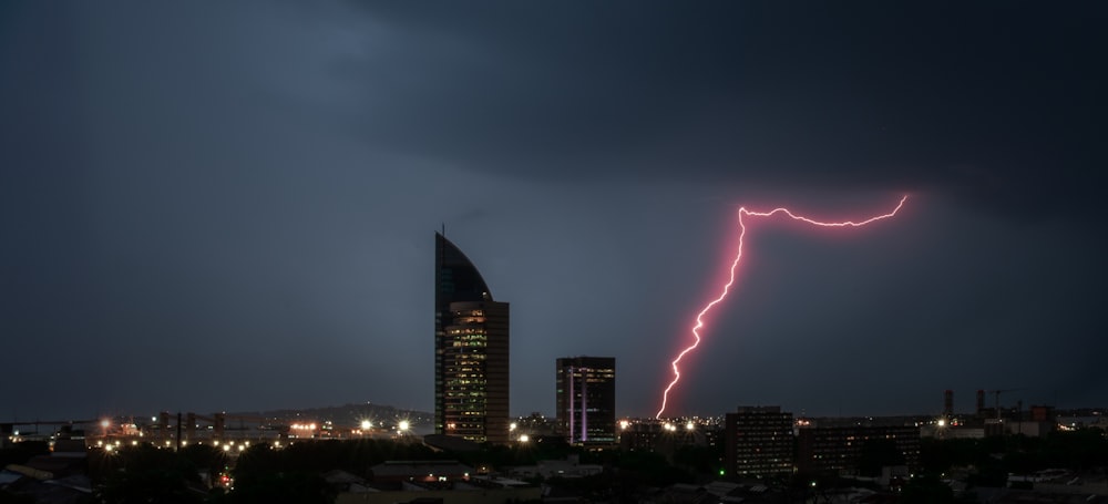 a lightning bolt is seen in the sky over a city