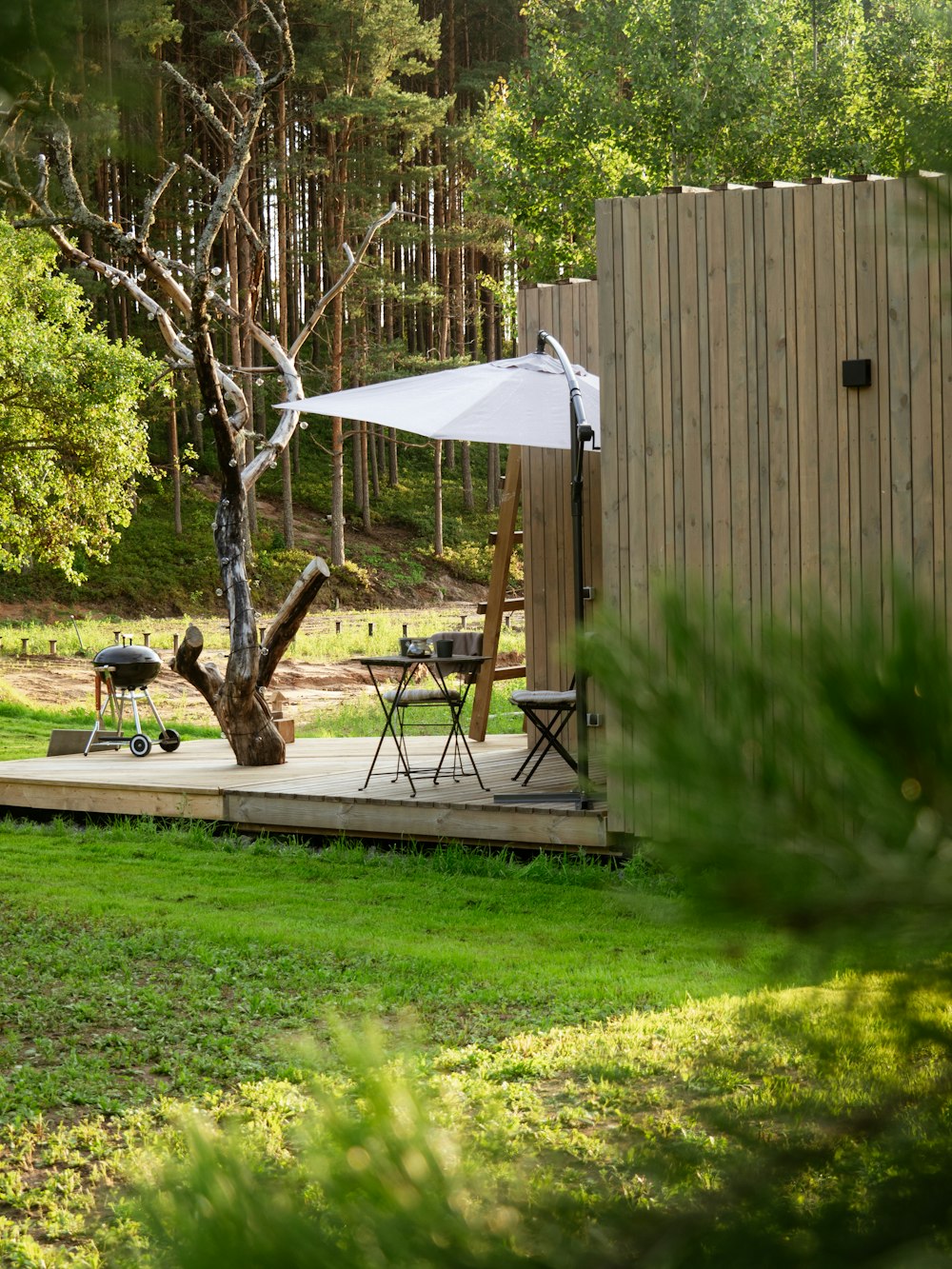 a small wooden structure with a table and chairs