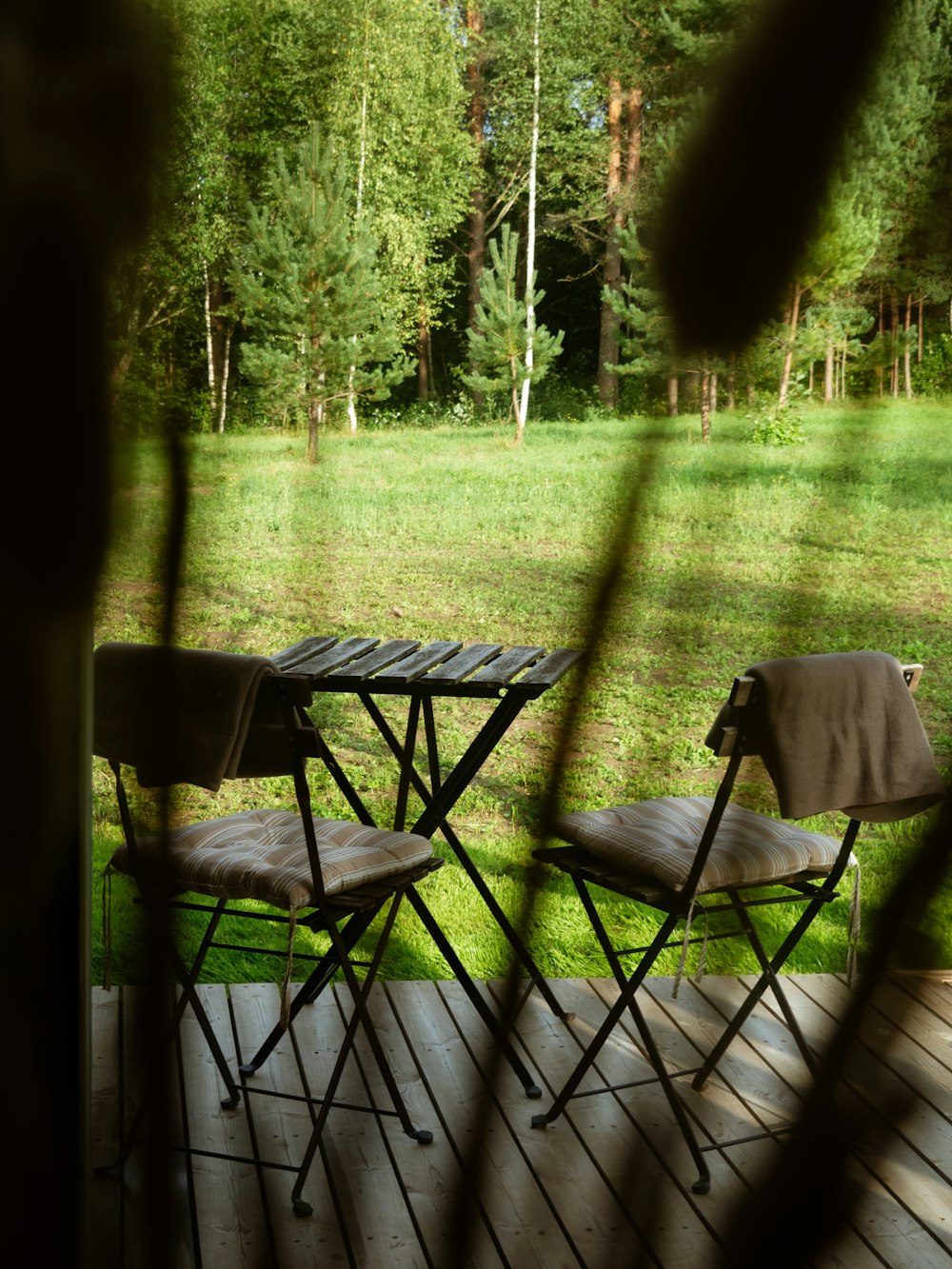 a couple of chairs sitting on top of a wooden deck