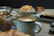 Artisan pastries displayed on a wooden platter next to a cappuccino with latte art.