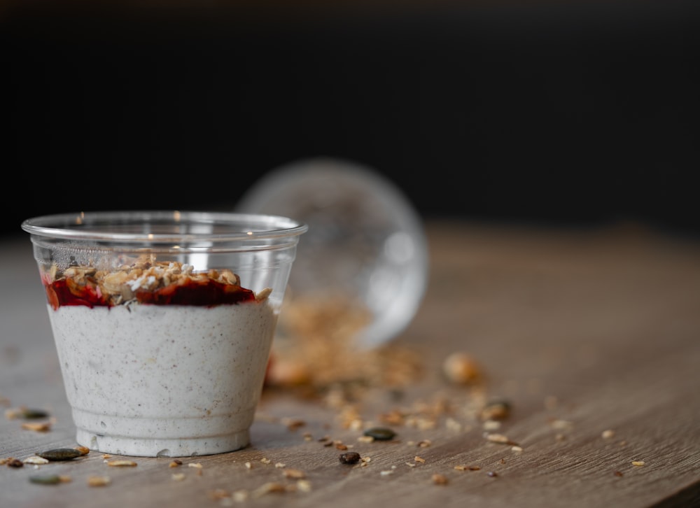 a cup of food sitting on top of a wooden table