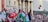 A large crowd of people is gathered outside a building with columns, holding flags and signs. The flags include Turkish and Palestinian national flags. The participants appear to be engaged in a demonstration or protest.