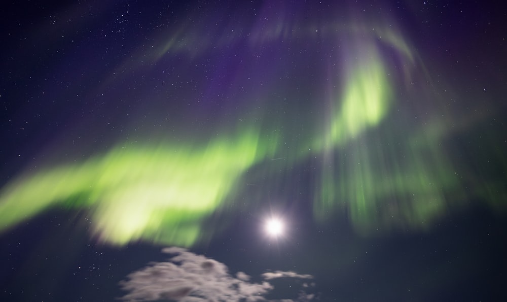 a bright green and purple aurora bore in the night sky