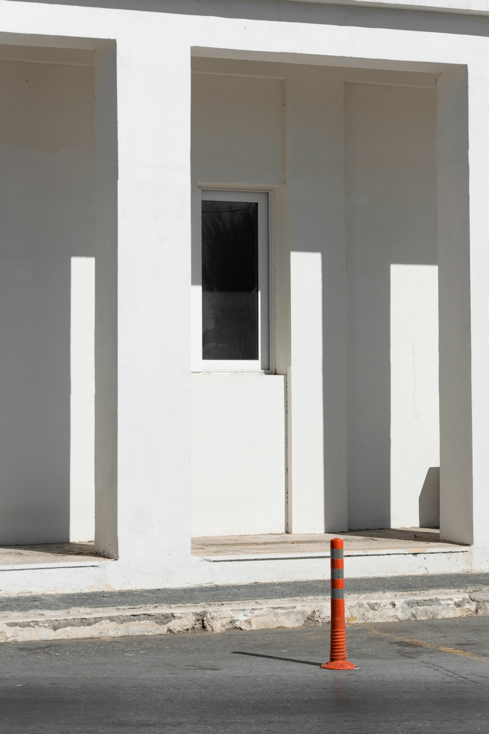 a white building with a traffic cone in front of it