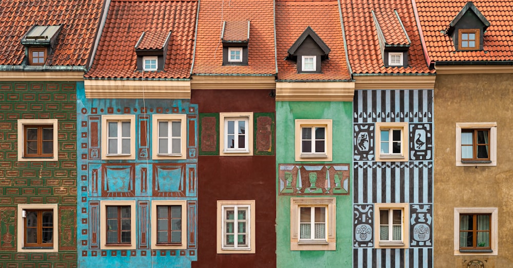 a row of multicolored buildings with windows